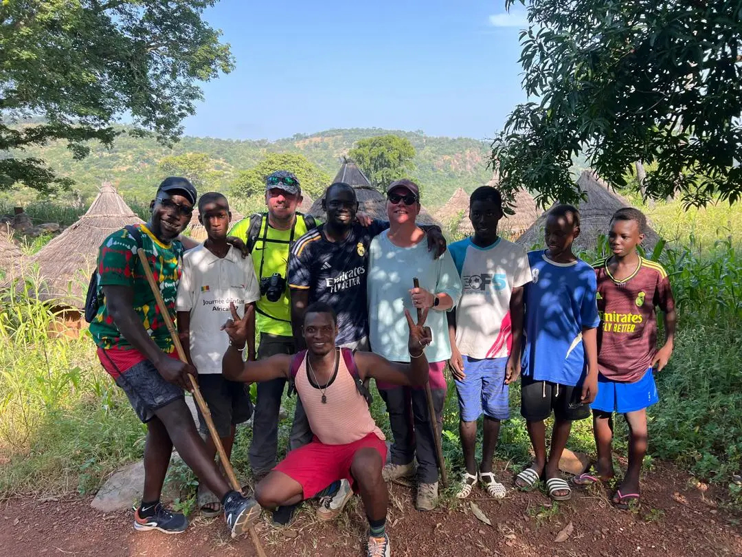 Groupe de voyageurs et habitants réunis en pleine nature